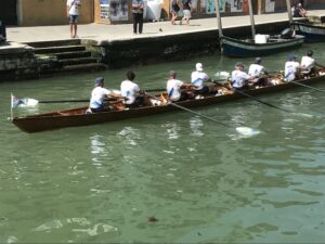 Rowers on a canal in Venice